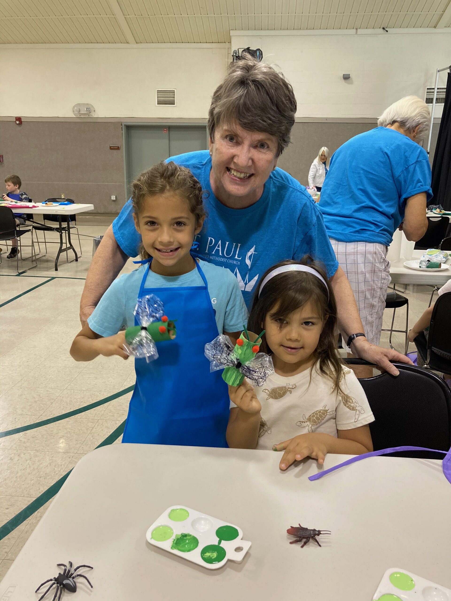 woman and children showing craft project